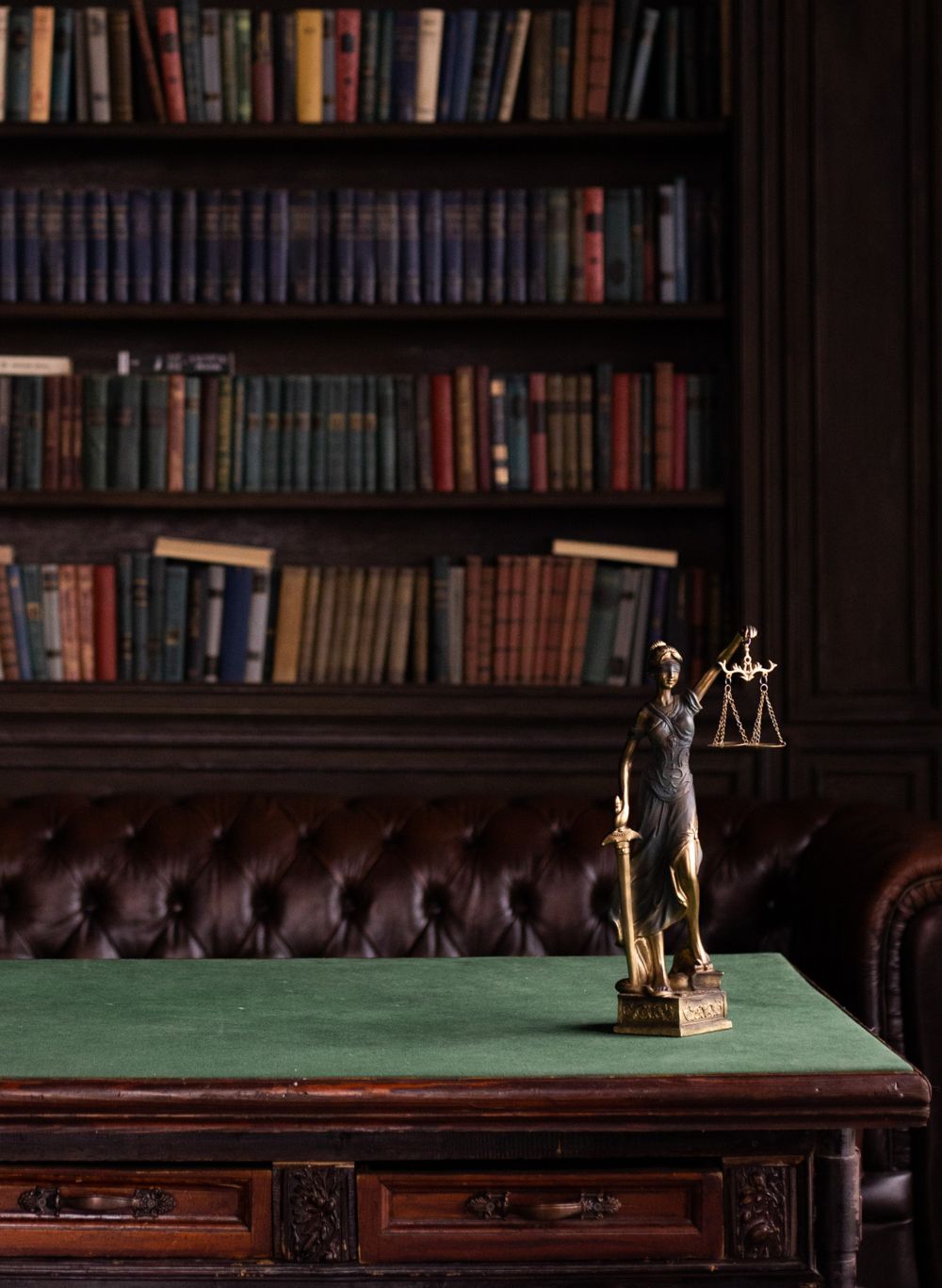 A law library with Lady Justice on the desk